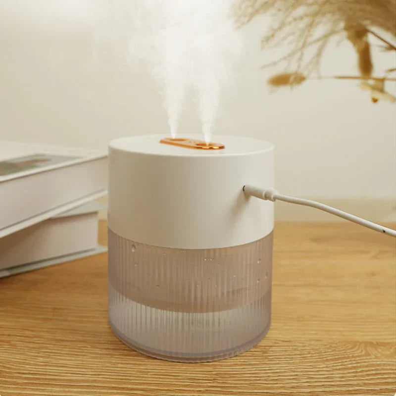 Humidifier Diffuser - White dual-nozzle humidifier emitting mist, with a power cable plugged into its side