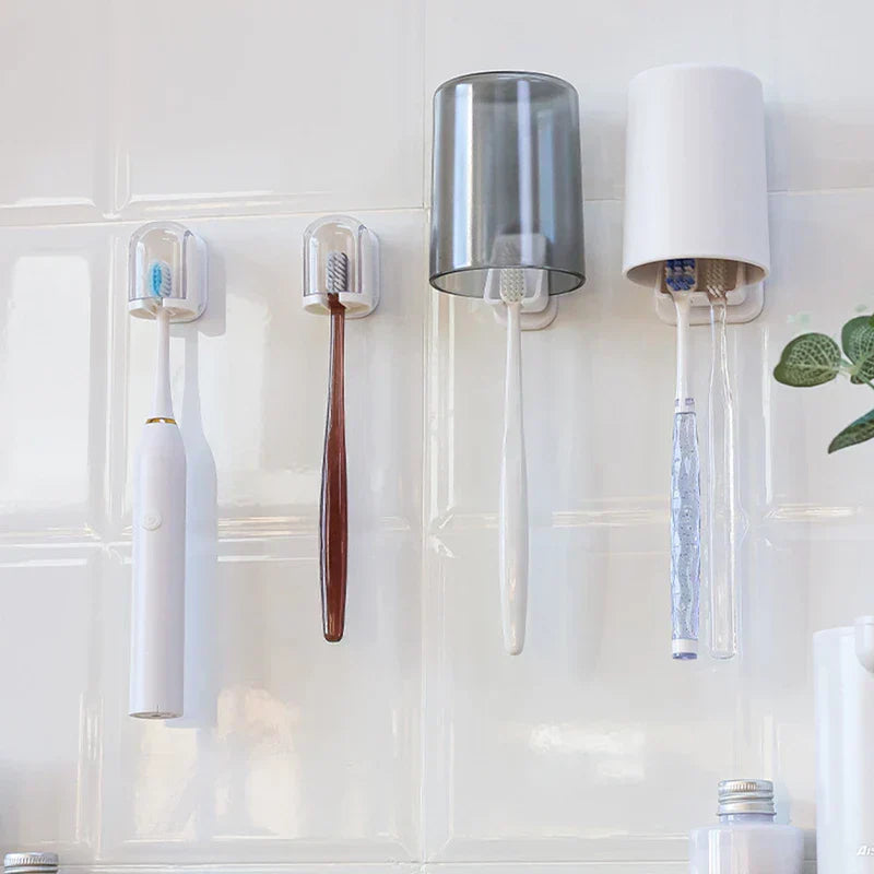 Toothbrush Holder - Four toothbrush holders mounted on a white tiled wall holding various toothbrushes and inverted cups