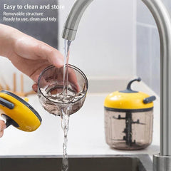 Smoothie Maker - Hand rinsing a disassembled pull chopper cup under a running kitchen faucet, complete unit on counter nearby