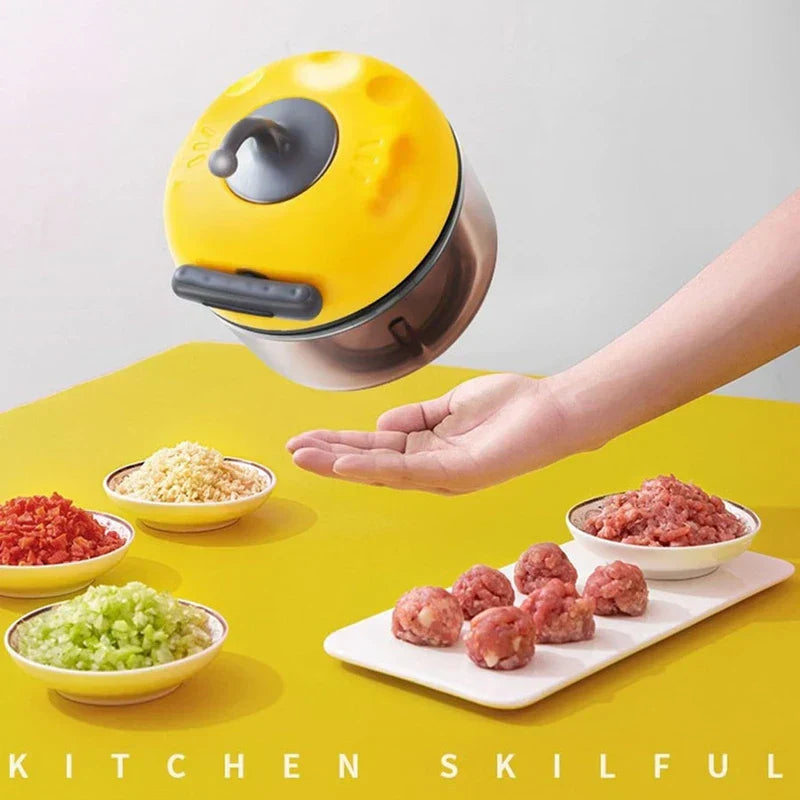 Smoothie Maker - Compact chopper held above a counter with prepped ingredients including minced garlic, chopped vegetables, ground meat, and formed meatballs