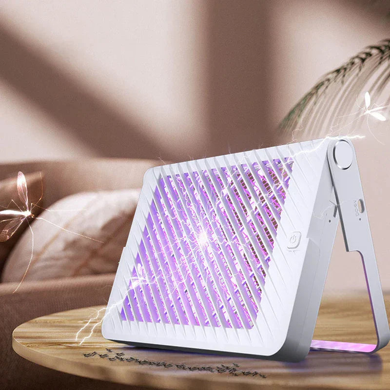 Racket Mosquito - Zapper unit placed on a wooden side table in a living room setting, with zapped insects visible on the table surface