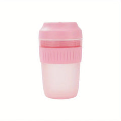 Electric Citrus Juicer - Light pink compact juicer unit with ribbed grip band and translucent juice reservoir