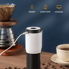 Electric Coffee Bean Grinder - Portable coffee grinder plugged in via USB cable, with coffee beans, a cup of coffee, and pour-over coffee maker on a wooden surface