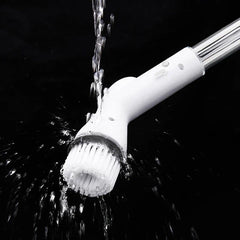 Electric Spin Scrubber - Water pouring over the angled white bristle brush head of an electric cleaning brush, with water splashing against a black background.