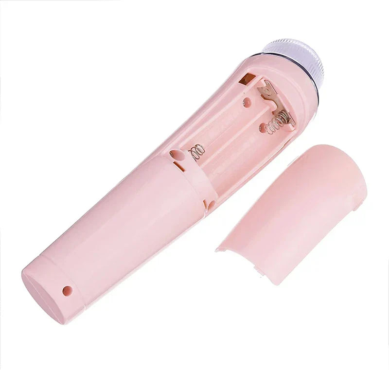 Pore Suction Cleaner - Pink handheld device with battery compartment open, showing internal springs and detached plastic cover.