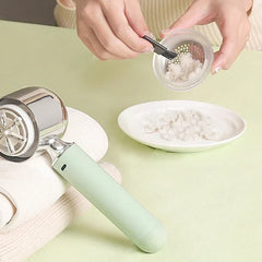 Trimmer - Two hands cleaning a lint shaver blade cover with a small brush, shaver rests on folded fabric.