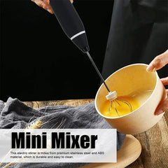 Electric Hand Mixer - Hand using the balloon whisk attachment to mix eggs in a ceramic bowl, with text overlay labeling the item as a mini mixer