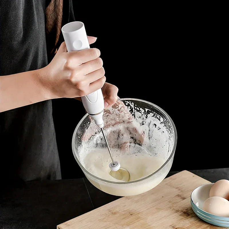Electric hand mixer whisk in use