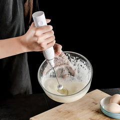 Electric hand mixer whisk in use