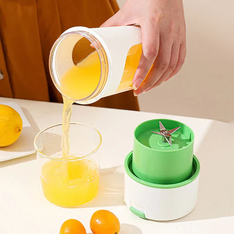 Juicer Extractor Machine - Hand pours yellow juice from a portable blender cup into a glass, with detached blender base and citrus fruits on a white table