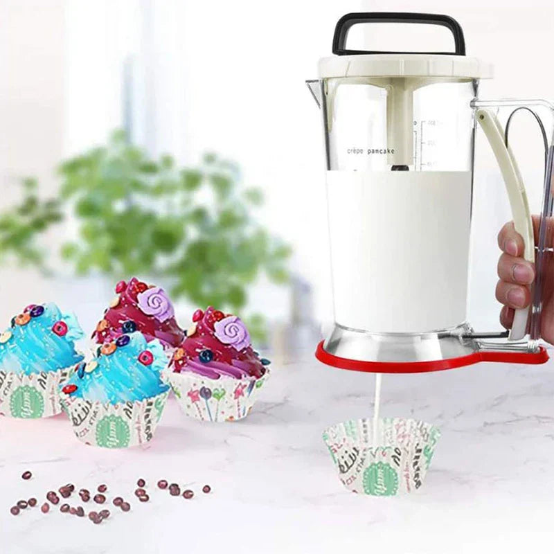 Electric Meat Grinder - Hand holds a batter dispenser dispensing white batter into a cupcake liner, decorated cupcakes sit on a counter nearby