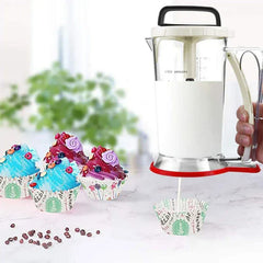 Electric Meat Grinder - Hand holds a batter dispenser dispensing white batter into a cupcake liner, decorated cupcakes sit on a counter nearby
