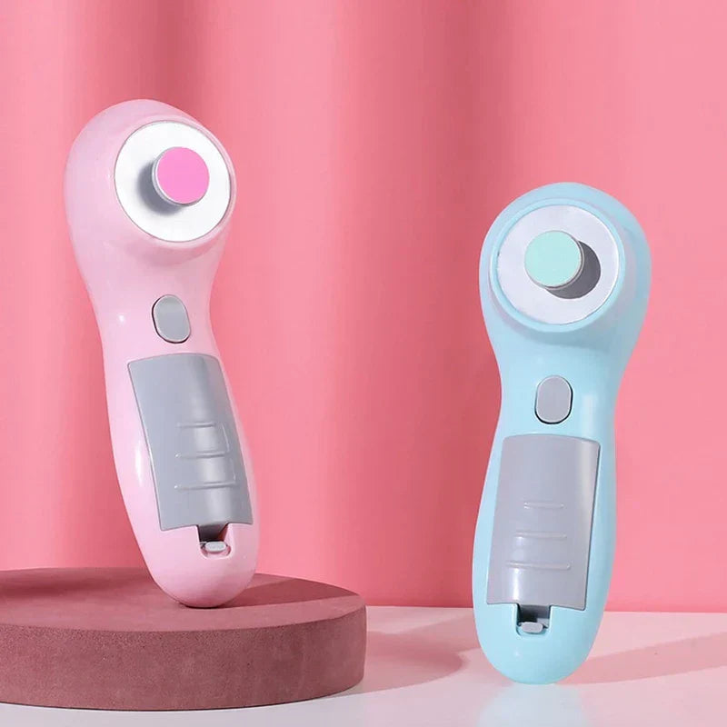 Electric Nail File - Two handheld nail care tools in pink and light blue, displayed on a raised platform against a solid pink backdrop