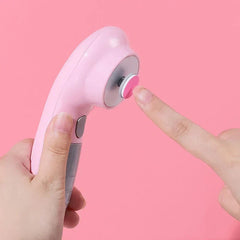Electric Nail File - Close-up of a pink electric nail trimmer held in one hand, finger of the other hand touching its rotating pad.