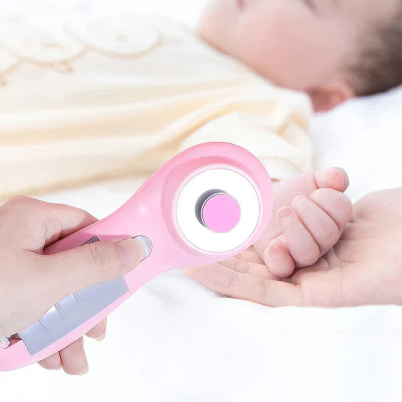Electric Nail File - Pink electric nail trimmer held near a sleeping baby's hand resting in an adult's hand.