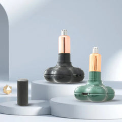 Hair Trimmer - Two colored handheld devices (black, green) with rose gold upper sections and USB ports, displayed on white tiered platforms with a dark ribbed cap nearby.