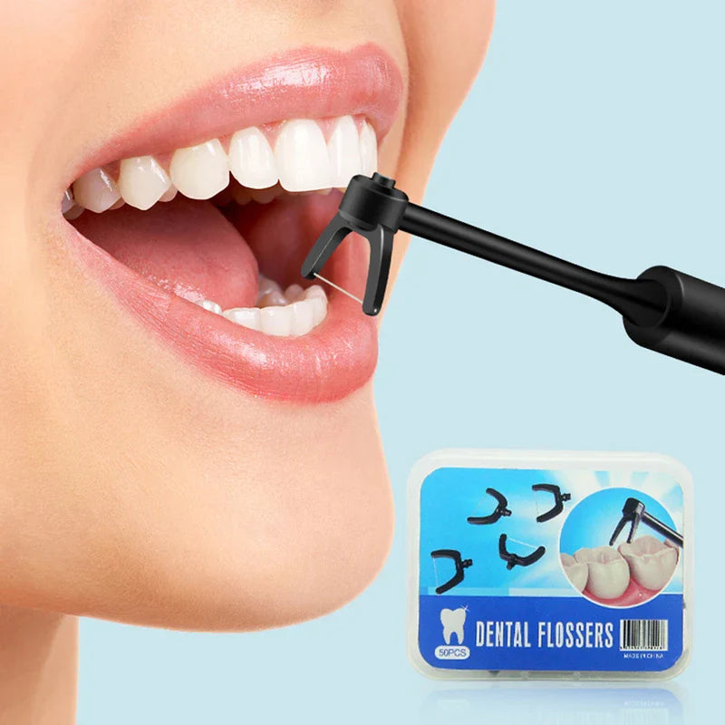 Oral Irrigator - Black flosser head positioned between upper and lower teeth, with a 50-count dental floss refill box visible.