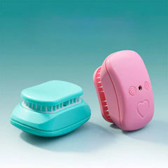 Electric Scalp Massager - Pink and teal units shown from angled side view, displaying compact rounded shape