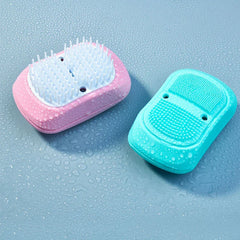 Electric Scalp Massager - Two wet grooming devices side by side: pink with white bristles, teal with textured silicone pads, on water-drop covered surface