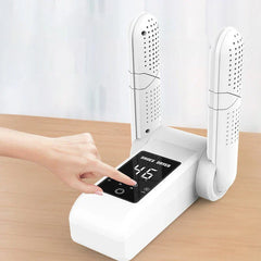 Boot Warmer - Hand pressing a control button on the shoe dryer's digital display panel