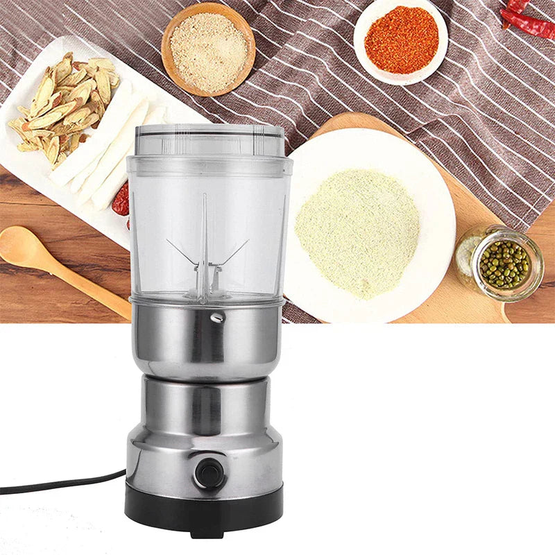 Coffee Spice Grinder - Front view of an upright electric grinder with stainless steel body and clear grinding cup, placed on a wooden surface surrounded by various whole and ground food ingredients.