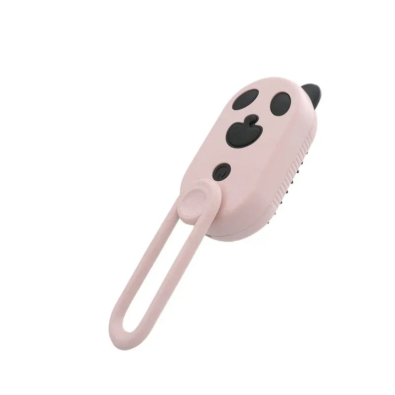 A pink electric spray handle massage brush with a cute cartoon face and hanging loop, on a white background.