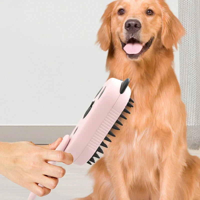 A hand holds the electric spray handle massage brush near a sitting golden retriever.