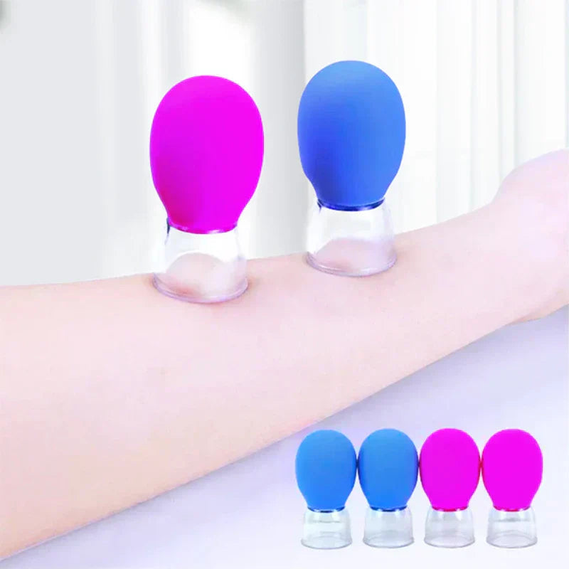 schröpfmassagegerät - Blaue und rosafarbene Schröpfmassagegeräte am Arm befestigt, darunter vier kleinere Einheiten.