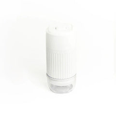 White handheld cordless device with a ribbed grip and clear lower base on a white background.