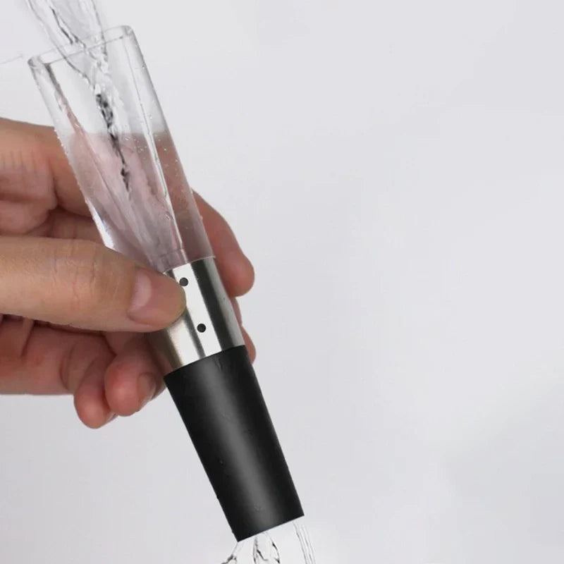 Electric Wine Aerator Pump - Hand holding the inverted pourer as water rinses through its clear upper section