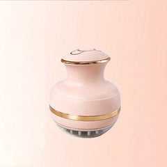 Energy Pen - Pink electric scalp massager with gold trim and soft silicone bristles on a light pink background