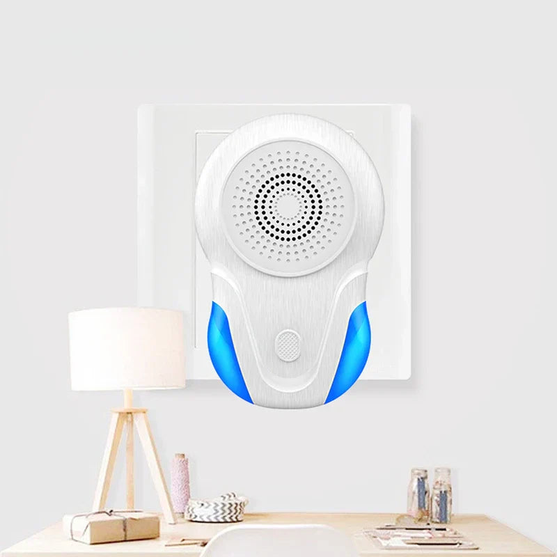 Electronic Indoor Pest Repellent Unit - Ultrasonic pest repeller plugged into a white wall outlet above a light wooden desk with a lamp and small items