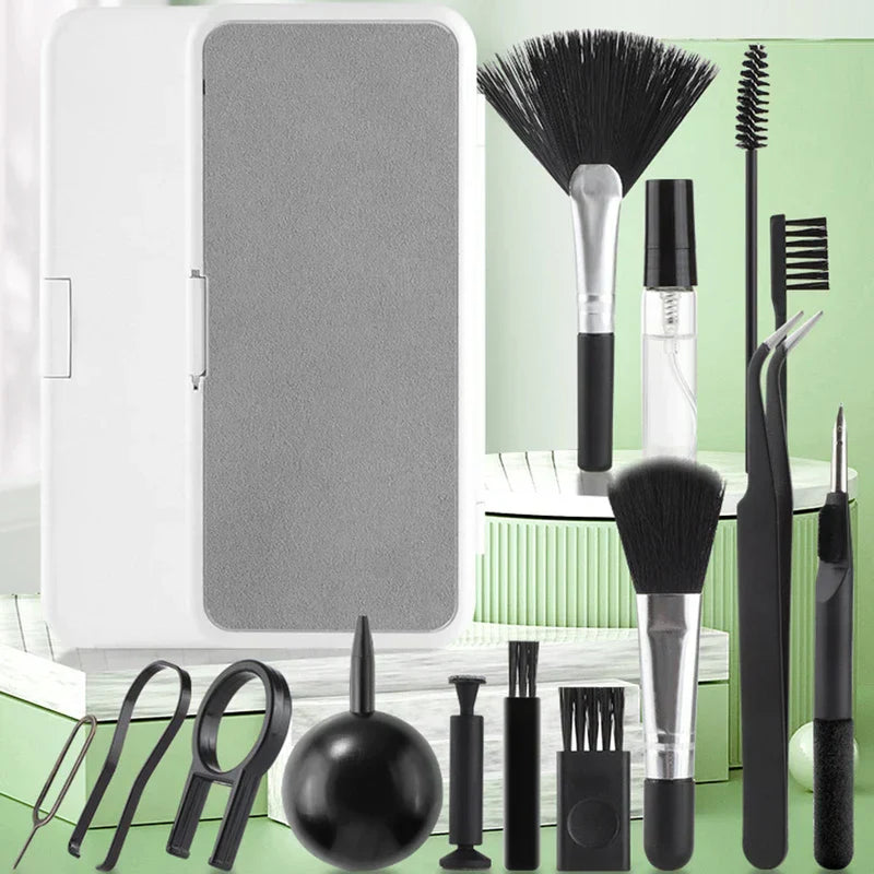 Assorted cleaning tools and a white case displayed on green stepped surfaces, showing an electronics cleaning brush kit.