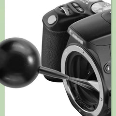 Electronics Cleaning Brush - Black rubber squeeze blower inserted into a Canon camera's open lens mount for sensor cleaning
