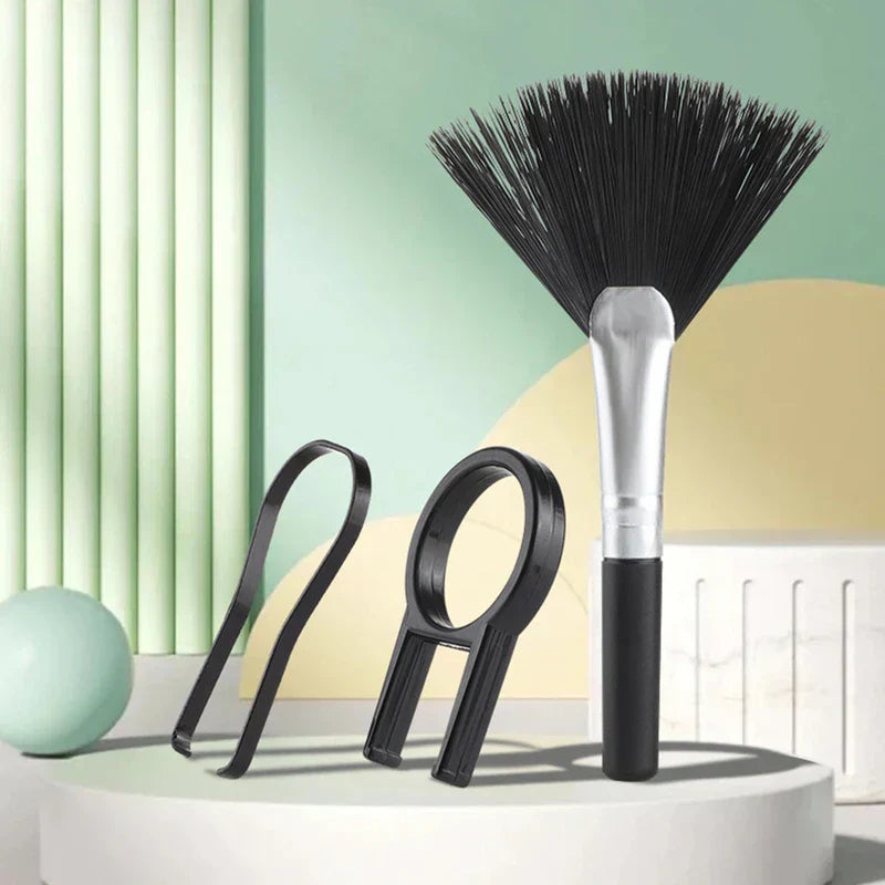 Electronics Cleaning Brush - Black lens cleaning brush, lens wrench, and filter ring tool displayed on a white platform with a green and yellow background