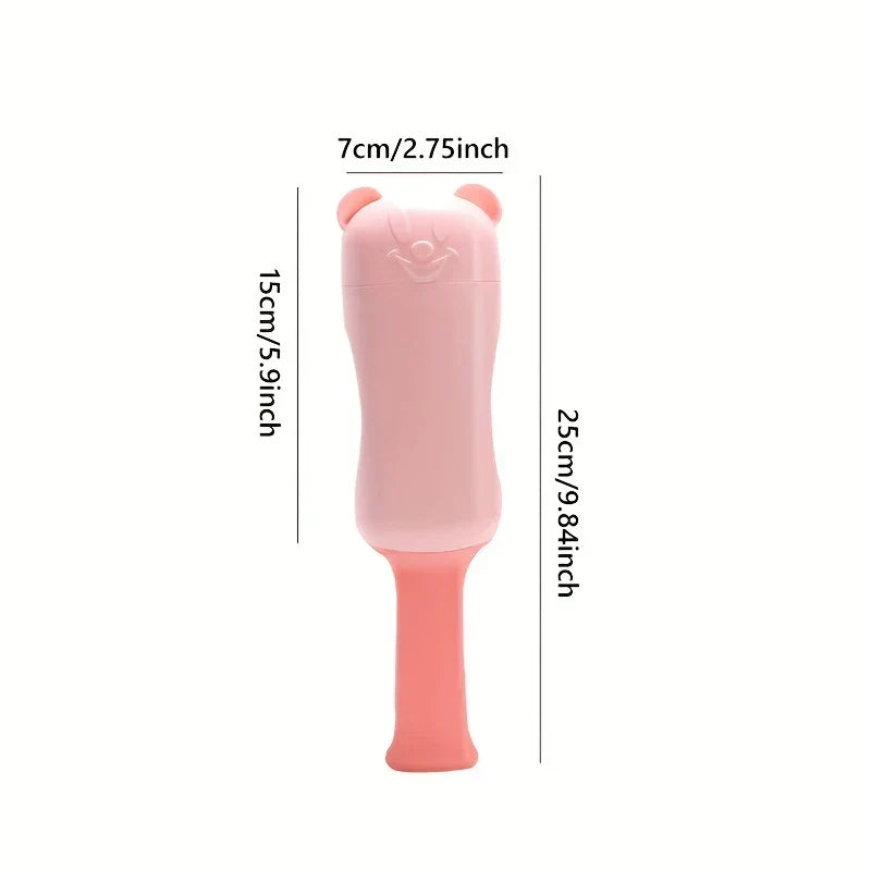 Pink bear-shaped plastic object with size measurement labels, on a white background.