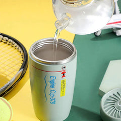 Suction Tumbler Mug - Light gray engine-styled tumbler with lid removed, having water poured into its stainless steel interior