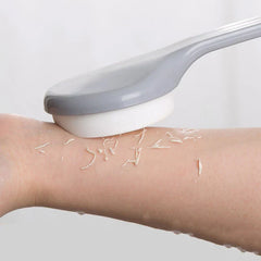 Loofah - The bath brush is rubbed against a wet arm, removing dead skin in visible strips