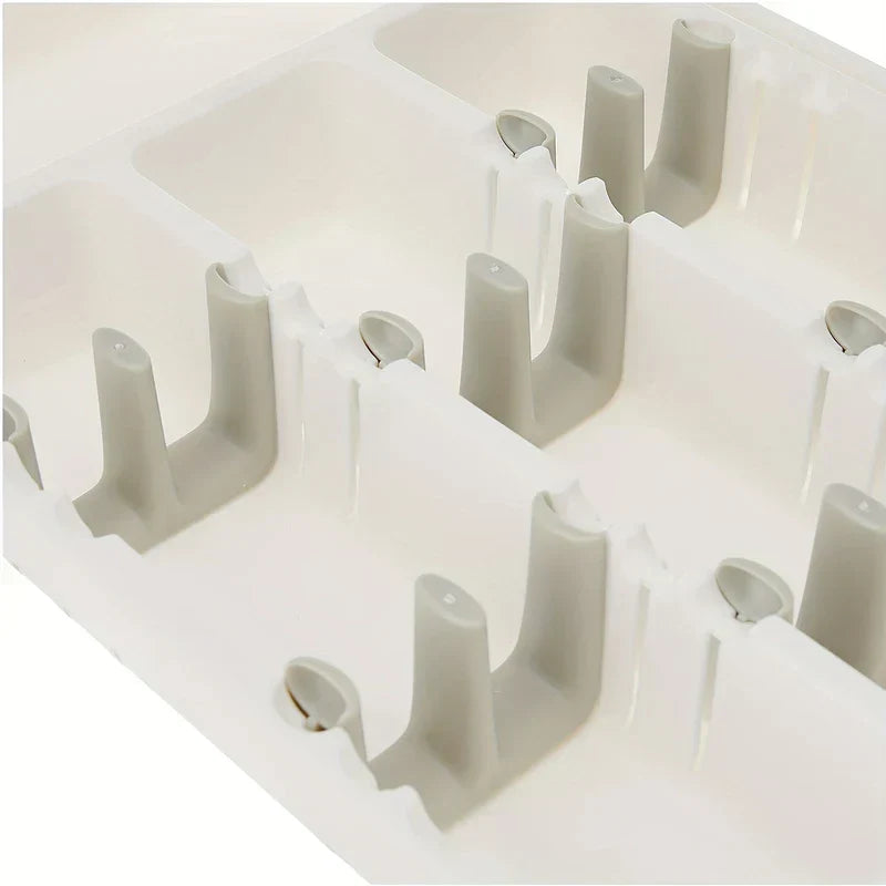 Cutlery Drawer - Close angled overhead view of connected white and light gray plastic grid tray dividers