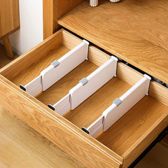 Closet Drawer Organizer - Three closet drawer organizers placed inside open wooden dresser drawer, dividing drawer space