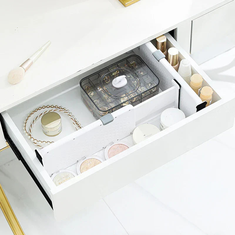 Closet Drawer Organizer - White adjustable drawer dividers separate makeup items inside a vanity drawer.