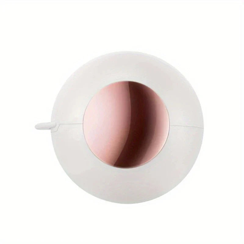 Sticky Lint Roller - White and rose gold compact spherical lint remover with protective cover tab, front view against plain white background