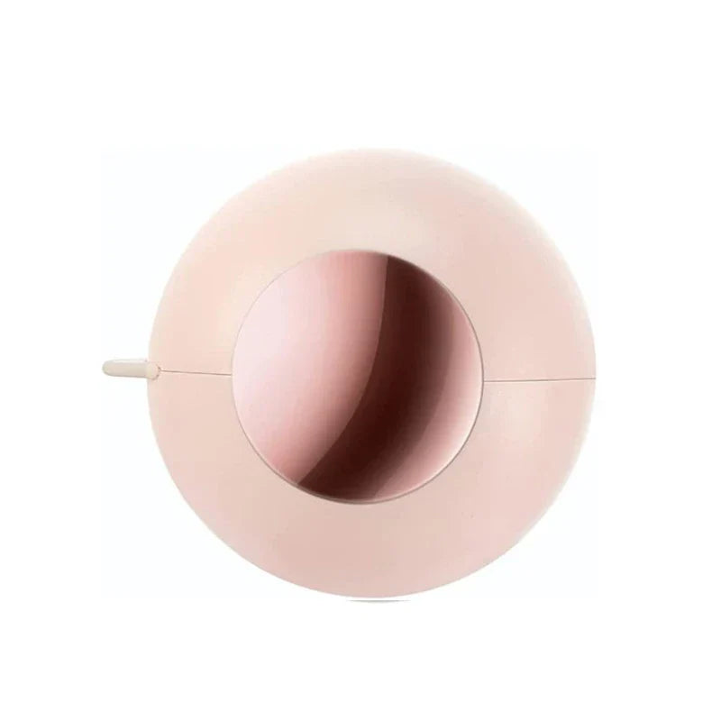 Sticky Lint Roller - Soft light pink round two-part case with central circular opening and small side tab, front view on white background.
