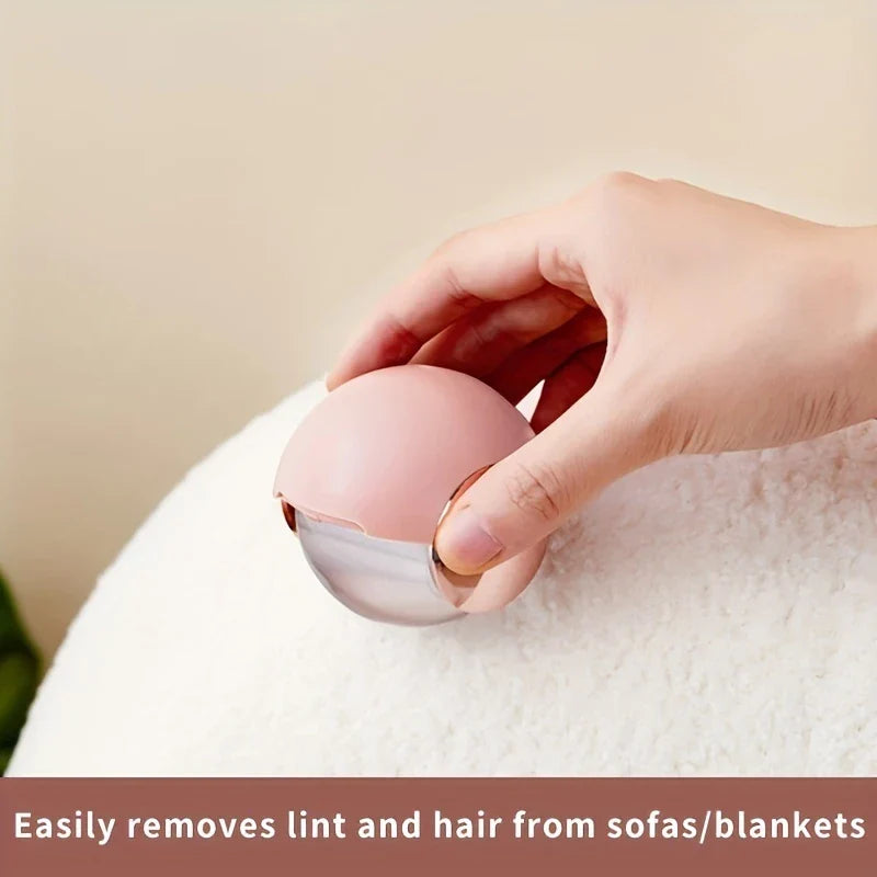Sticky Lint Roller - Blush pink reusable lint remover being used to lift lint and hair from a soft white plush fabric surface