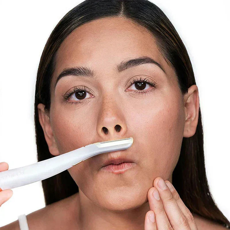 Eyebrow Razor - Woman using a white facial razor on her upper lip, one hand holding the tool, the other pulling skin at her chin