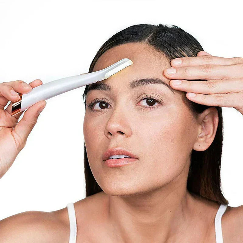 Eyebrow Razor - Woman using a white rose gold facial razor on her forehead, holding skin taut with her free hand