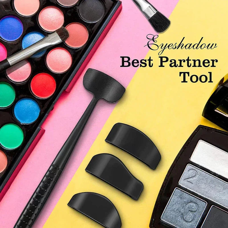 Eyeshadow Stamp Crease Applicator Tool - Flat lay of eye makeup tool with interchangeable heads, eyeshadow palette, and makeup brushes on a two-tone surface