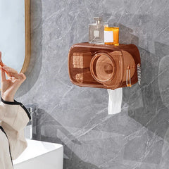 Cotton Pad Dispenser Holder - Unit installed on a gray marble bathroom wall, holding a rolled face towel and stacked cotton pads, with a towel dispensing from the bottom slot and skincare items placed on the top shelf