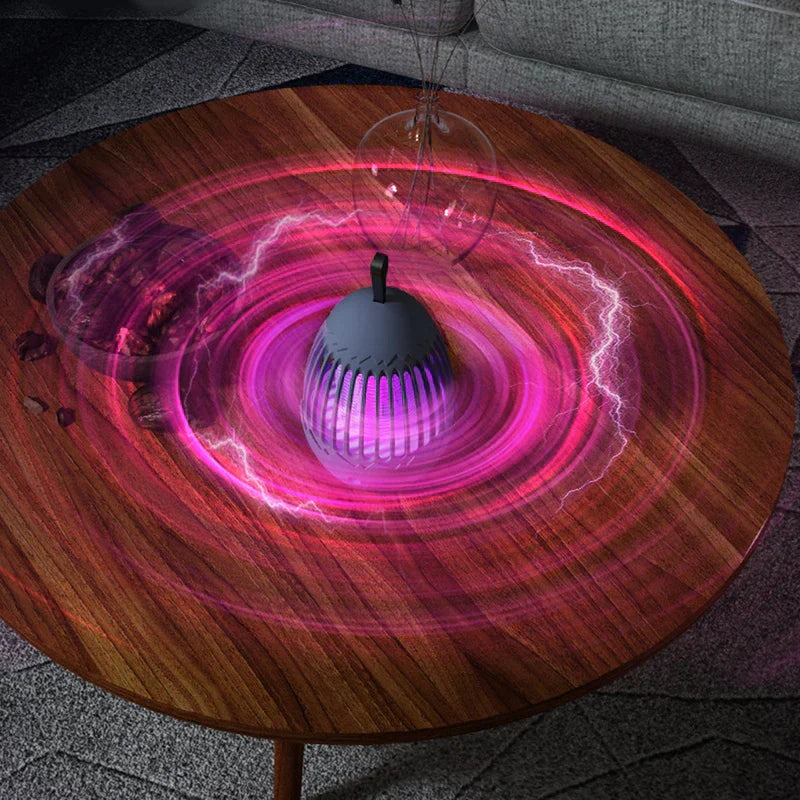 Bug Repellent Machine - Gray device placed on a wooden living room coffee table, with visual effect rings surrounding its base