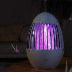 Bug Repellent Machine - Light gray egg-shaped purple-lit bug zapper with visible electric arcs, surrounded by illustrated mosquitoes on a wooden table.